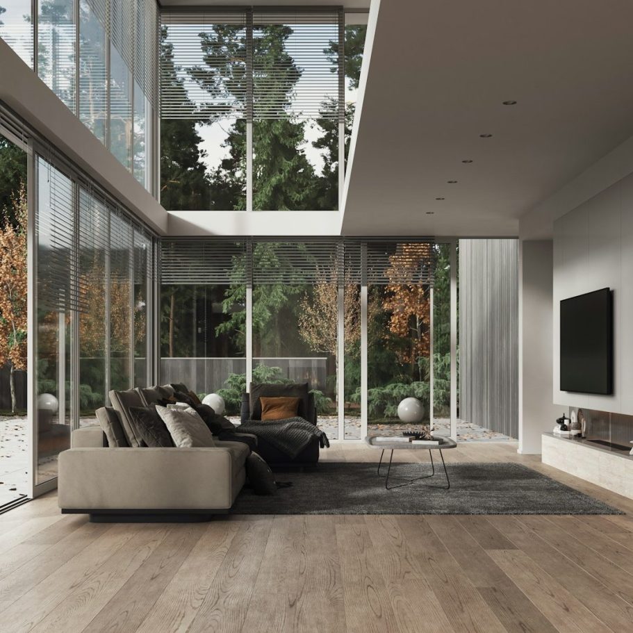 Salon moderne avec de grandes fenêtres, canapé beige et télévision murale. Salon moderne avec de grandes fenêtres, canapé beige et télévision murale.